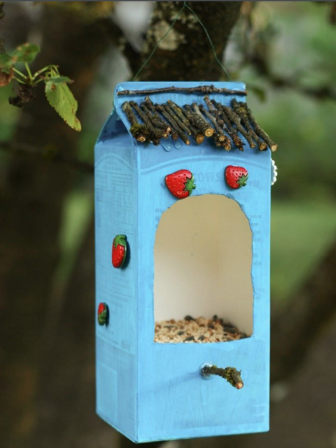 A bird feeder made from a milk carton