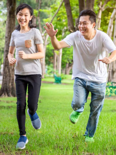 Man tagging woman running