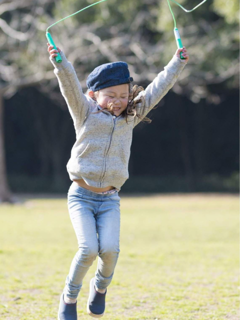 Young girl outdoors with a jump rope