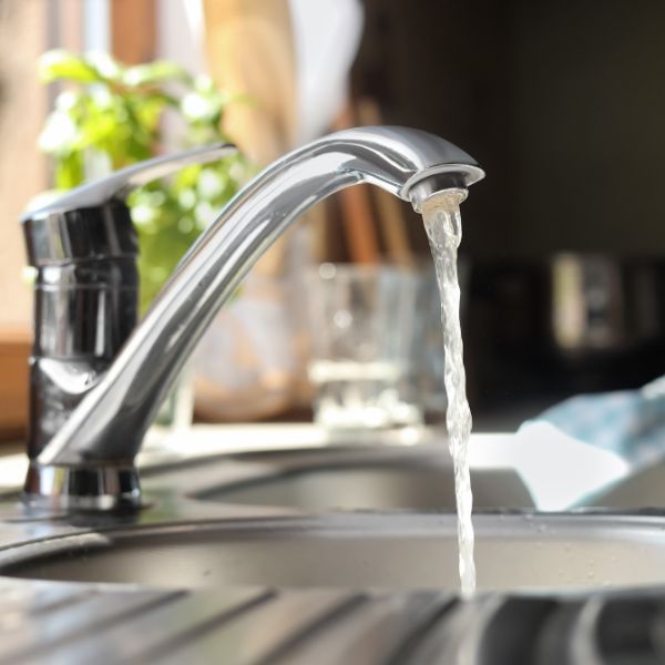 a sink faucet running with water flowing from it