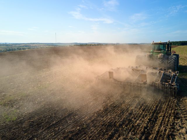 nitrous oxide being released from soil as a plow tills a field