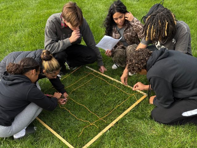 Students take part in a quadrat sampling on the school grounds.