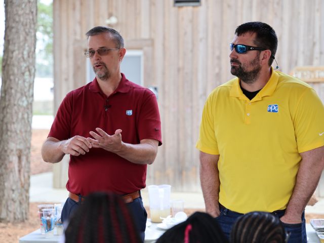 PPG employees speak to a group of students participating in a greening STEM program.