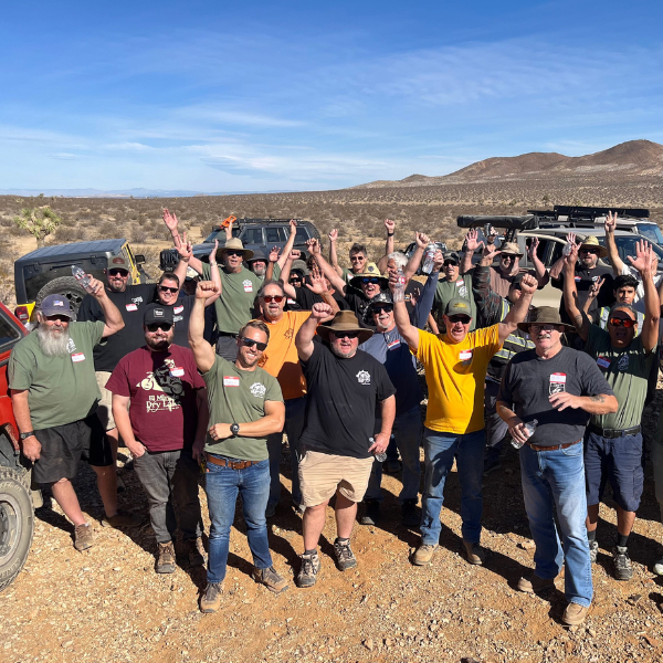 A group of people with their hands up outdoors