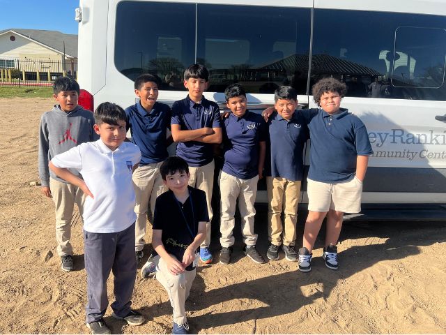 a group of students stands together before an outdoor education program