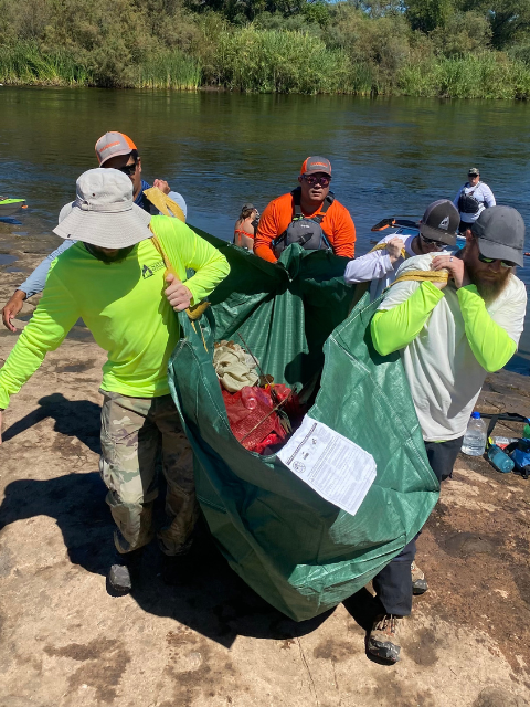 People removing trash from the river