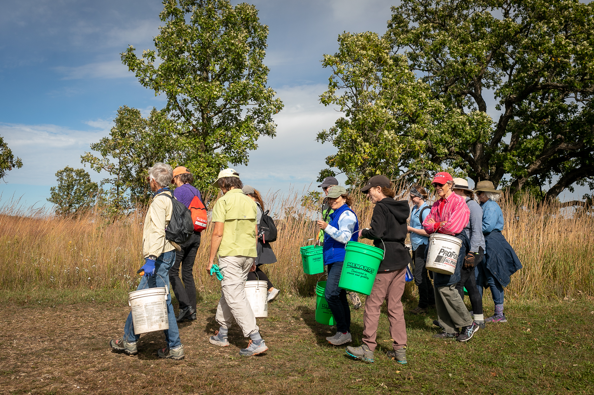 Volunteers carrying buckets during NPLD activity on Ice Age Trail.