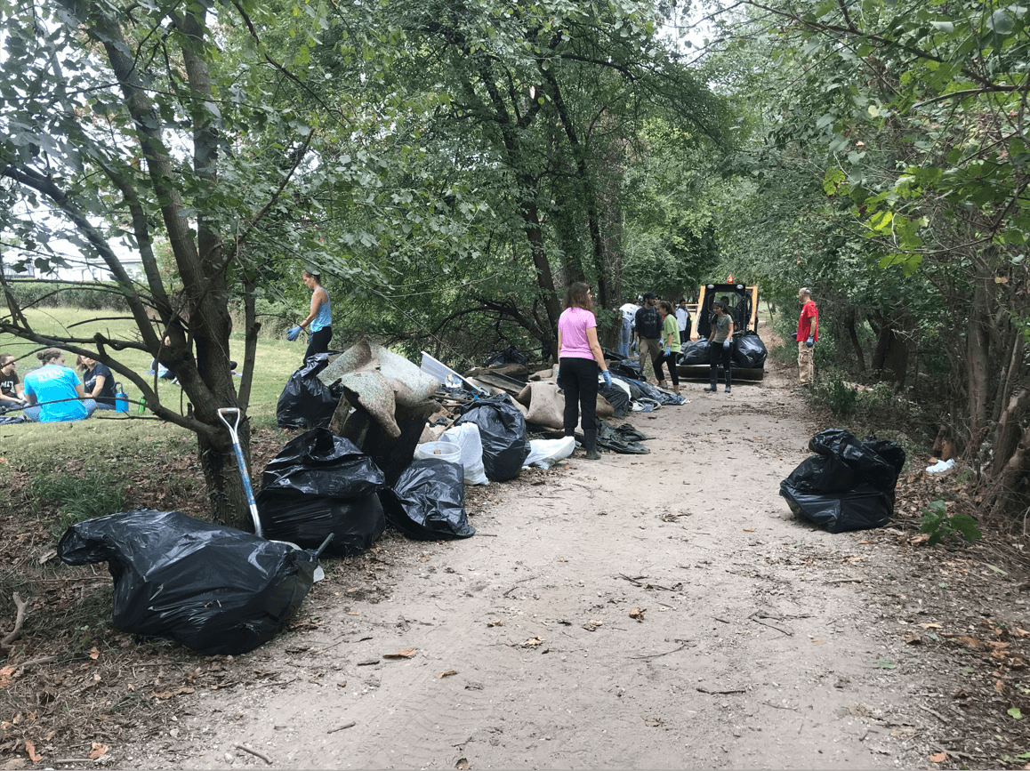 Volunteer counting full trash bags collected