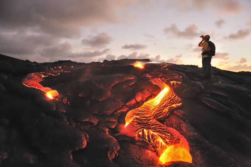 Photo of tourist taking a picture of a volcano
