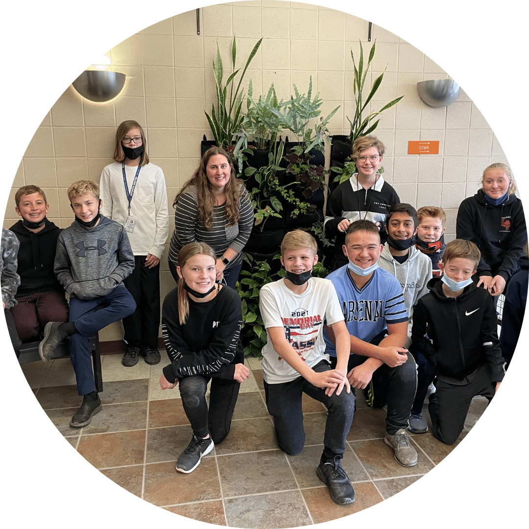 Teacher Kate Czapla with a group of students looking smiling
