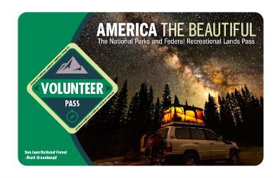 image of the volunteer pass, written across top: American The Beautiful The national parks and federal recreational lands pass with picture of starry sky tree lined horizon and converted camper SUV.