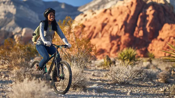 Young woman riding her bike in Red Rock Canyon