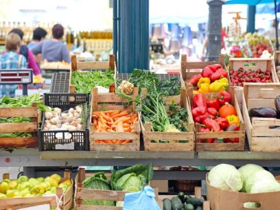 summer produce in wooden boxes at a farmers market