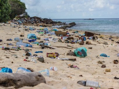 a beach with plastic trash covering the sand 