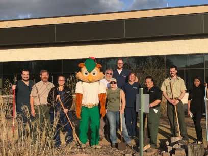 Woodsy Owl and the volunteers from the Lone Star Family Health Clinic