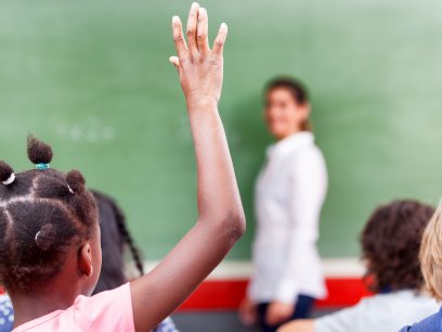 Student raising hand in class