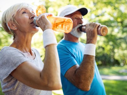 Older people hydrating at the park