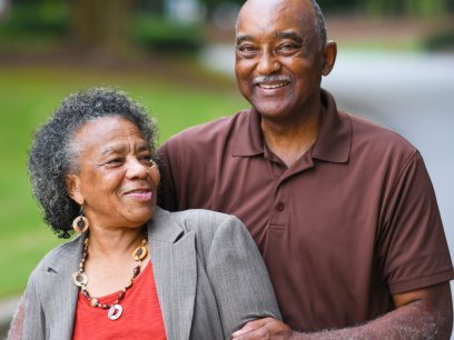 Mature couple smiling in a convertible car