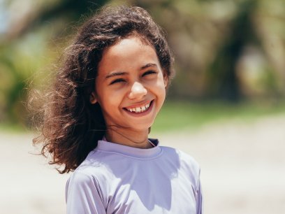 Girl on the beach in protective sunwear 