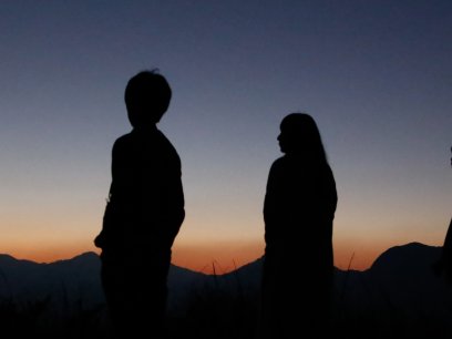 Group of youth looking at evening sky waiting for stars