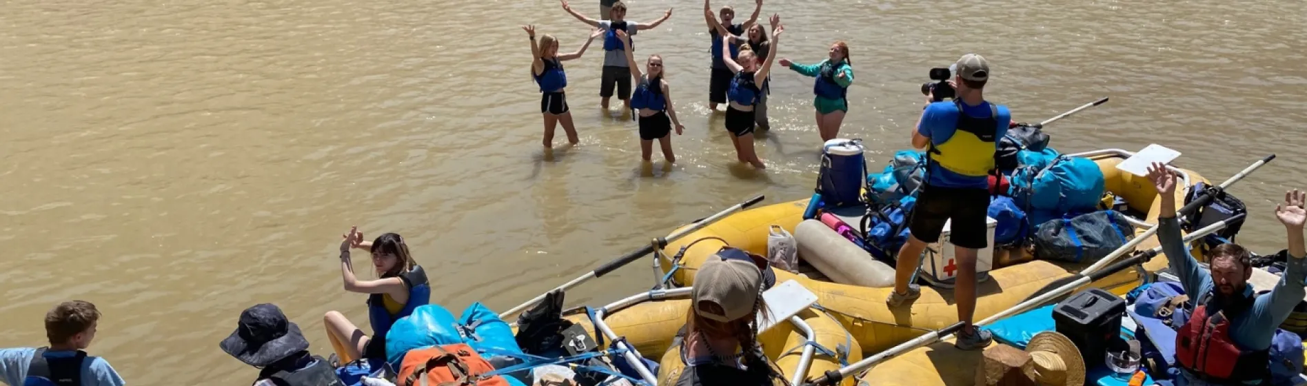 Photo of students celebrating environmental education project in river