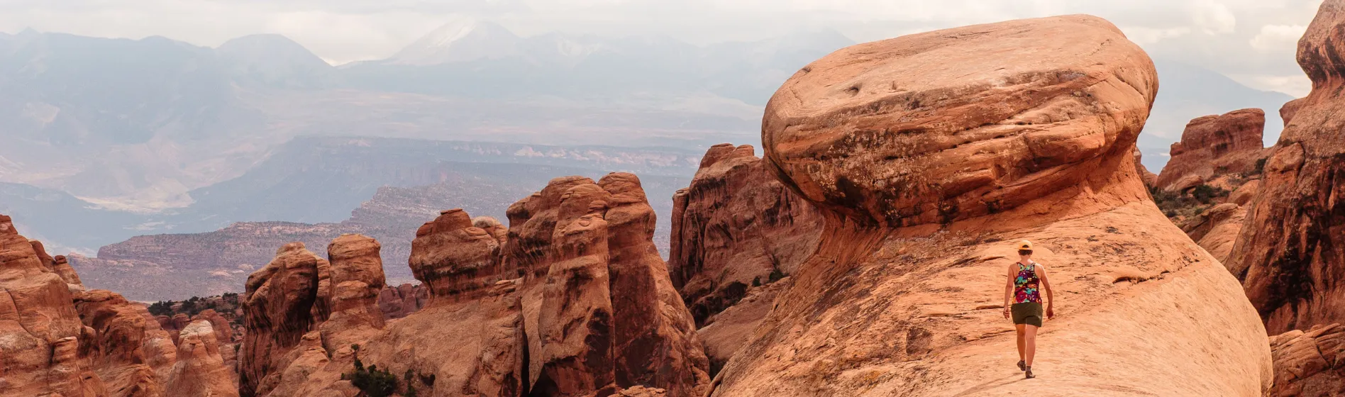 Woman hiking on large rock in the west