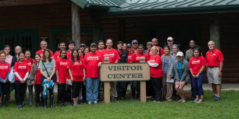 group of national public lands day volunteers stand for group picture around the visitor center at big thicket national preserve