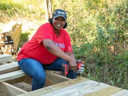 Photo of woman building a boardwalk on public lands