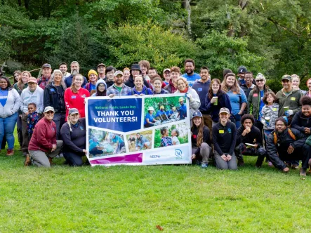 group of volunteers on National Public Lands Day stand for a group photo outside
