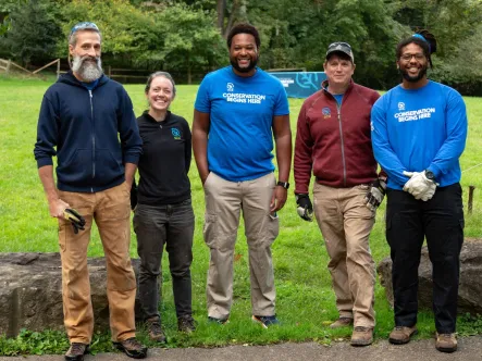 a diverse group of community leaders stand together smiling on National Public Lands Day 