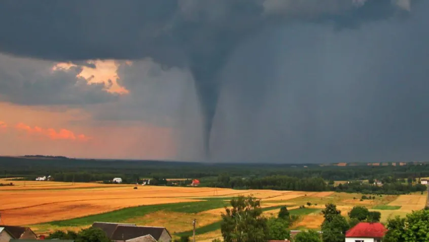 Tornado over a field seen from a distance