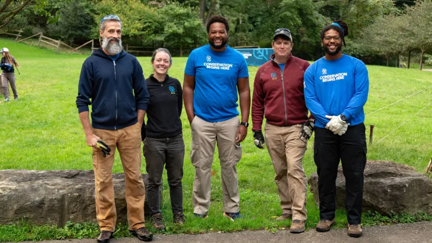 a diverse group of community leaders stand together smiling on National Public Lands Day