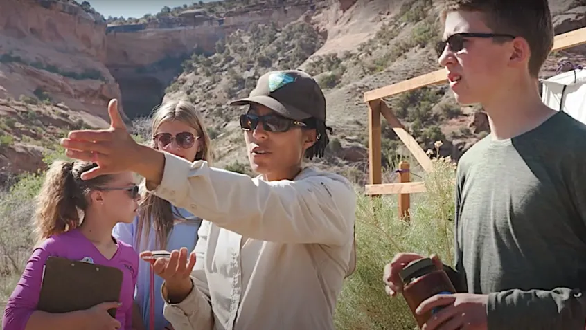 A BLM scientist instructs a group of students during an environmental education lesson in Colorado Canyon