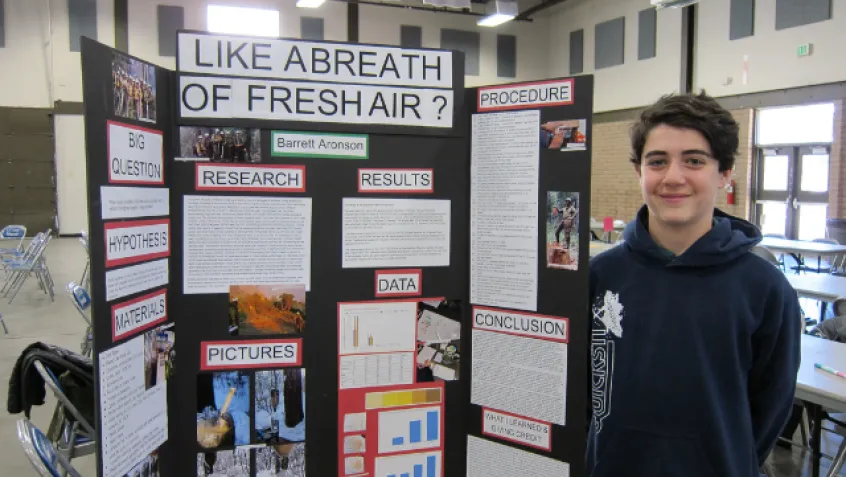 Student showing a science project about air quality during wildfires