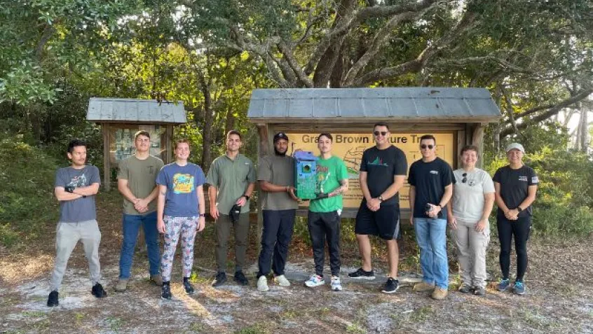 a group of Department of Defense employees stand together after a successful National Public Lands Day project