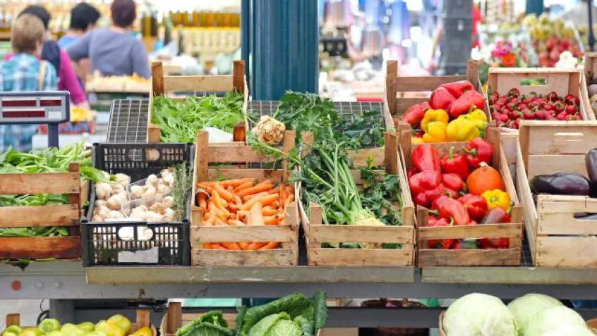 summer produce in wooden boxes at a farmers market