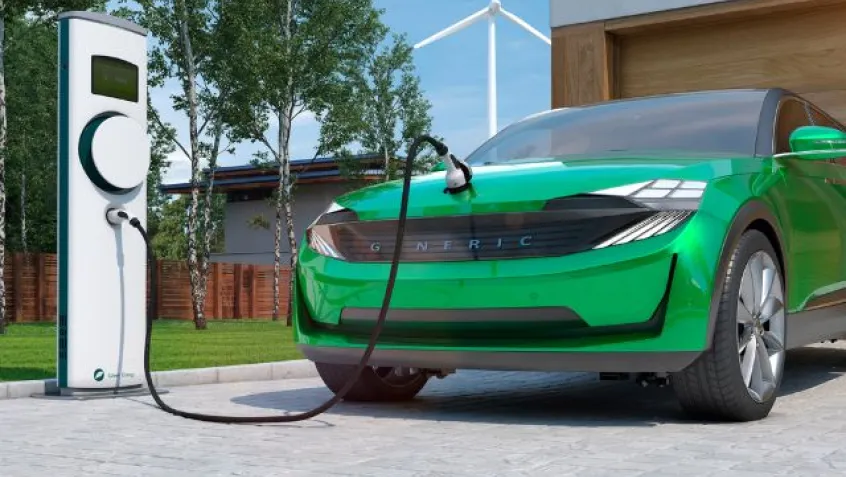 an image of a generic electric car with charging station and wind turbine in the background