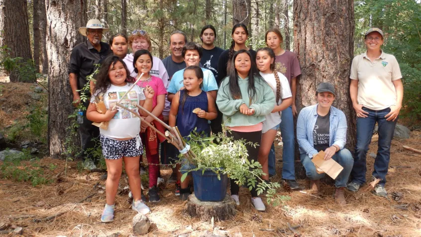 a group of native american youth stand together for a photo during a seed collection project