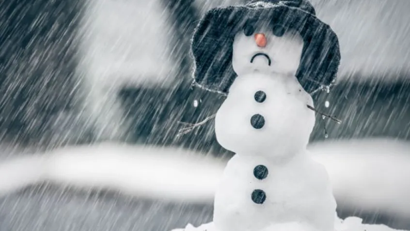 a melting snowman in the rain