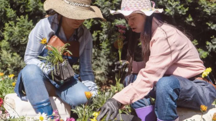 two women work getting their spring garden ready during Earth Month
