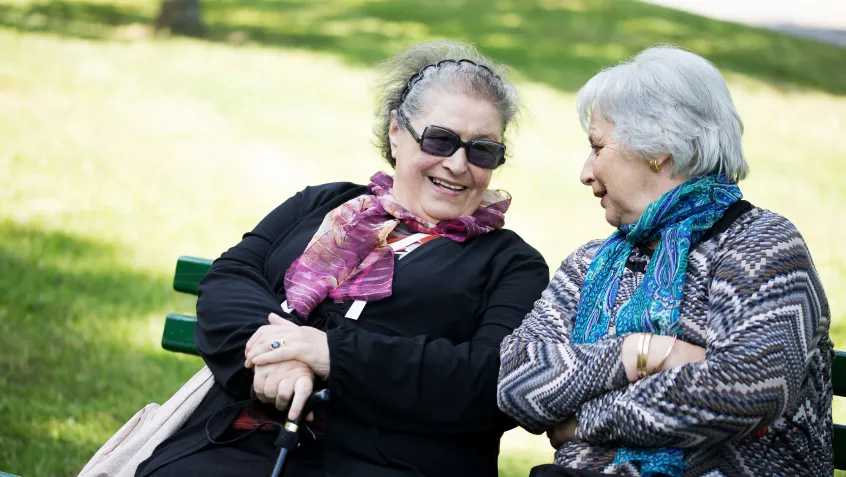 Two senior ladies having a conversation in a park