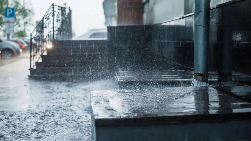 Rainwater flowing from downspout
