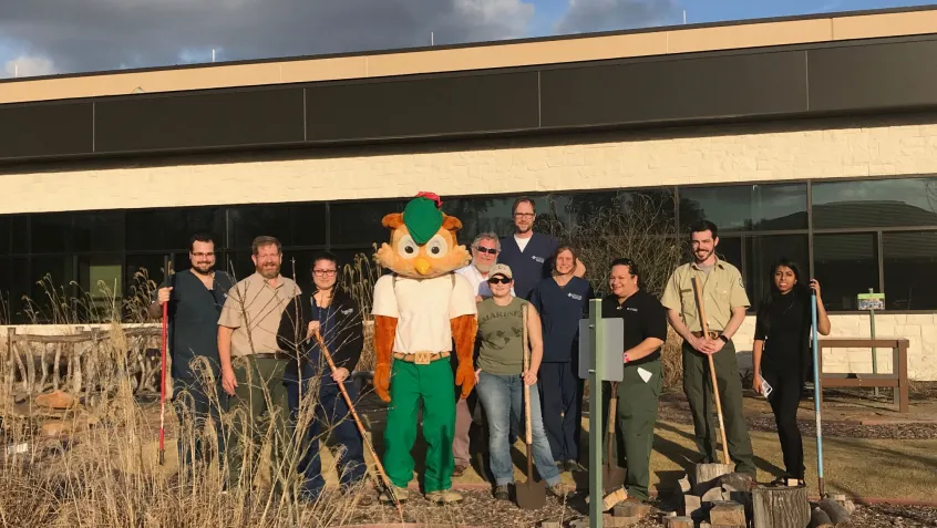 Woodsy Owl and the volunteers from the Lone Star Family Health Clinic