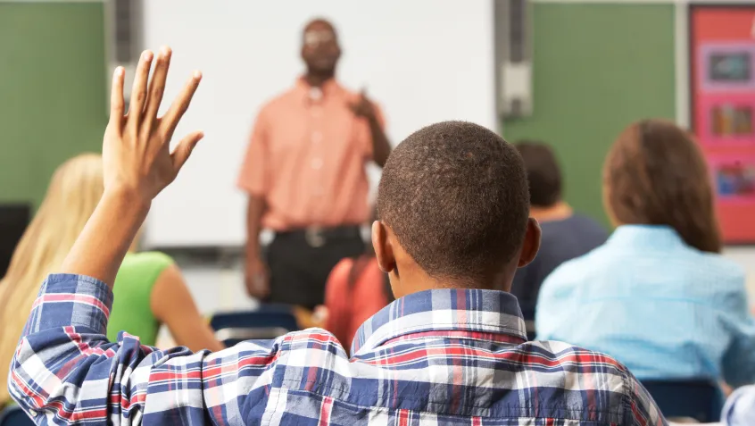 Student raising hand in class