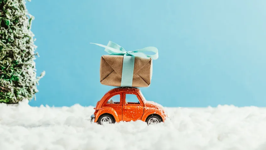 Toy car driving with a gift