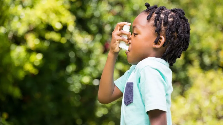 Kid using inhaler outside