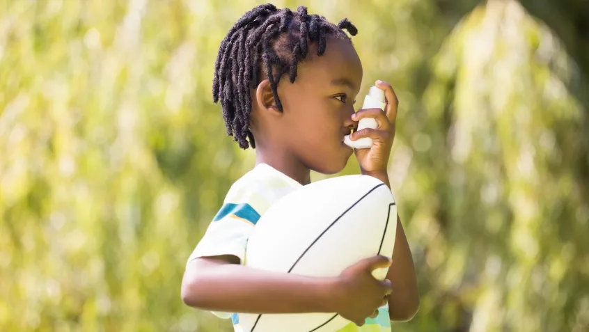 Child using an inhaler outdoors