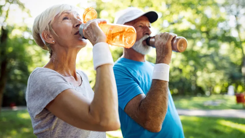 Older people hydrating at the park