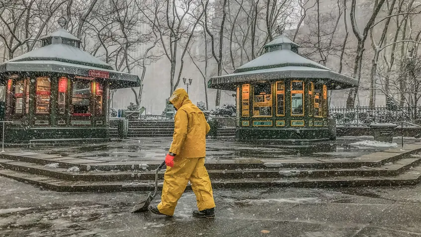 Man shoveling snow at a public park