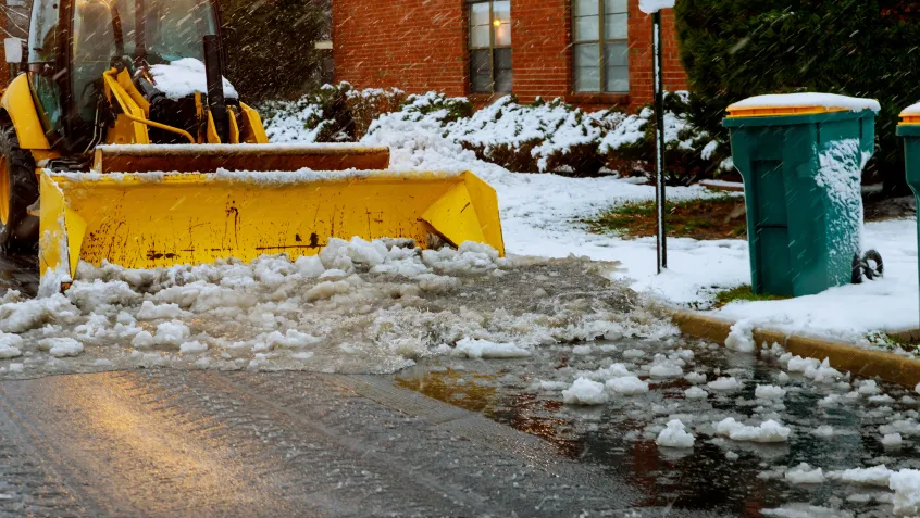Truck shoveling snow off street